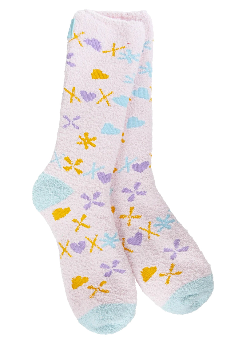 Light pink fuzzy socks with light blue toe and heel, as well as X's and hearts in light blue, purple, and orange.