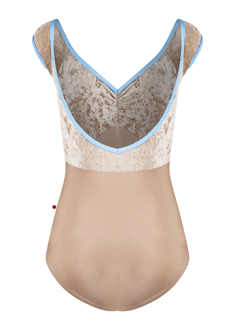 Yumiko Elli cap sleeve leotard in tan, with crushed velvet bodice and light blue trim.