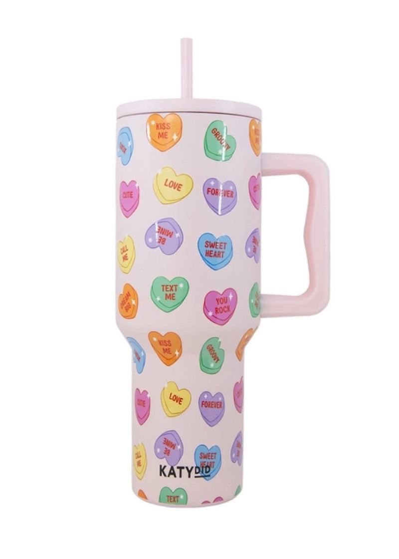 light pink tumbler with handle and conversation heart pattern